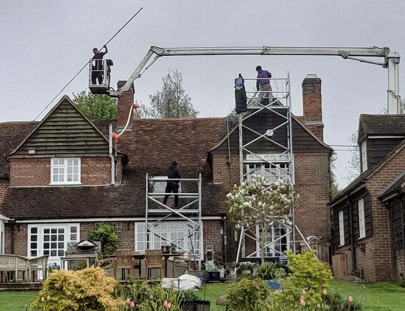 The Moss Cleaners using cherry picker and scaffolding to clean roof safely and professionally in Wellesbourne, Warwickshire